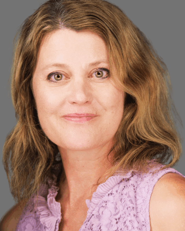 A headshot of a woman smiling