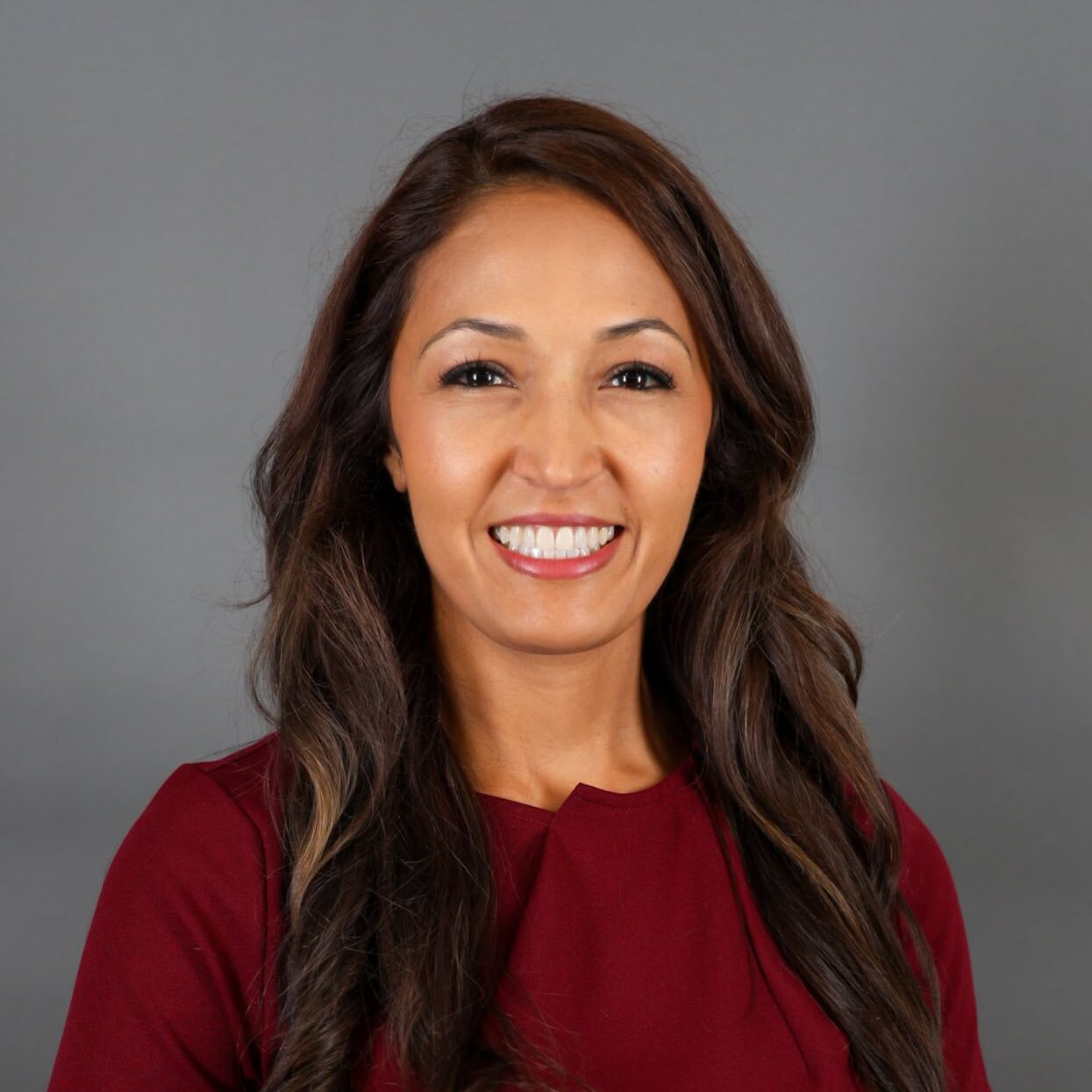 A woman with long hair smiling